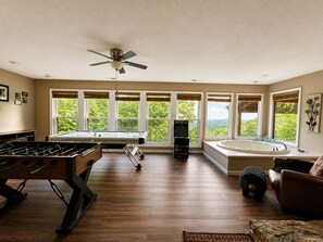 A spacious room with a pool table, foosball table, and a hot tub. - Worth The Climb, Hot tub, bears and Views! (Gatlinburg)
