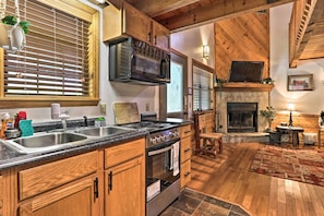 Enjoy cooking in this well-appointed kitchen with a stainless steel range hood, double sink, and oven.