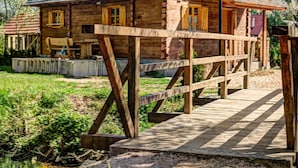 A wooden log cabin with a wooden deck leading to the entrance. - Wonderful private villa for 4 people with A/C, WIFI, TV and pets allowed (Vrelo Korenicko)