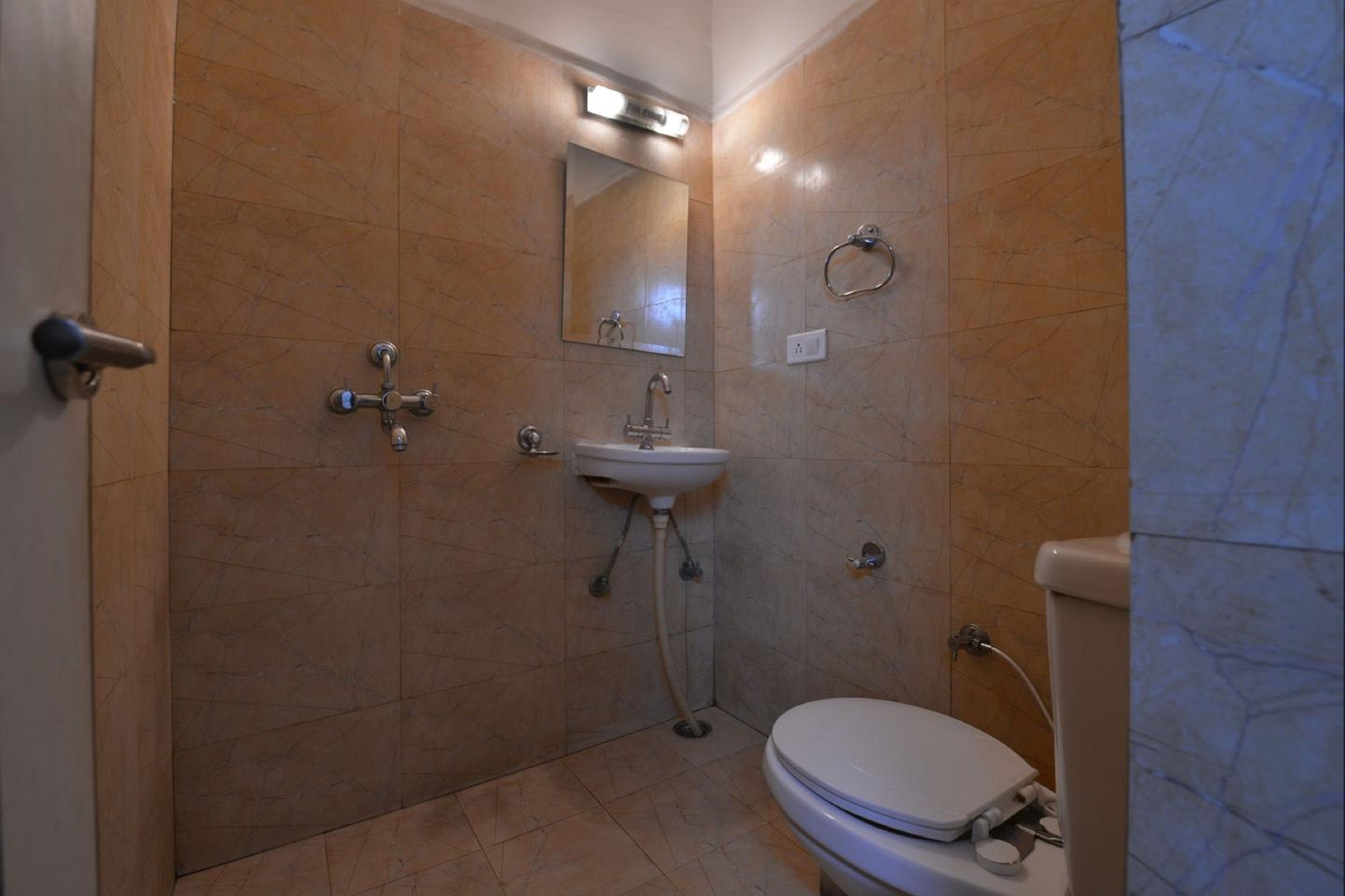 A bathroom with a toilet, sink, and shower.