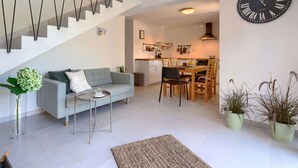 A modern living room with a grey sofa, a coffee table, and a staircase. - Stunning private villa for 6 people with WIFI, A/C, private pool, TV and terrace (Pazin)