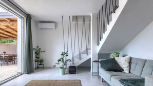 A modern living room with a sofa, a coffee table, and a staircase. - Stunning private villa for 6 people with WIFI, A/C, private pool, TV and terrace (Pazin)