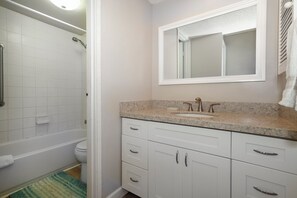 A bathroom with a shower, toilet, sink, and mirror. - Charming & Affordable Couple's Retreat w/ Ocean Views from Every Room (Princeville)