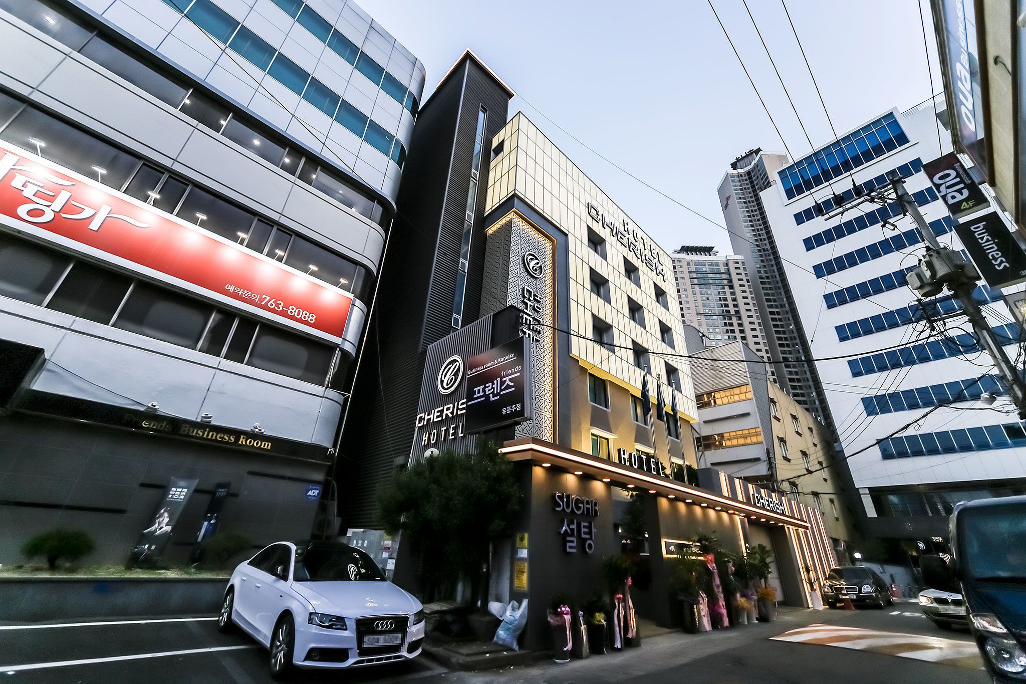 A hotel with a prominent sign for 'CHERISH HOTEL' and 'Sugar Seoul' on the facade.