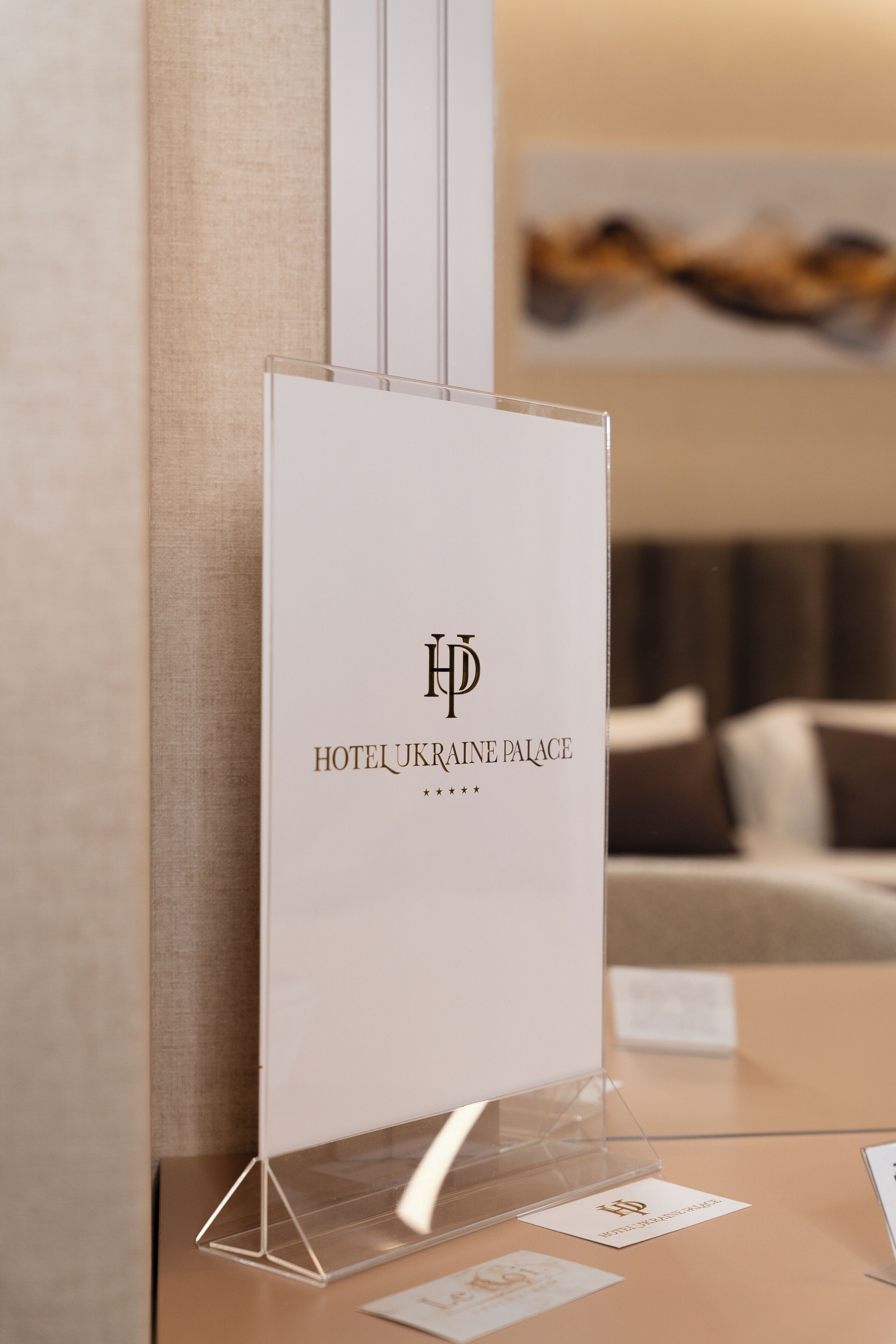 A hotel sign with the logo and name "HOTEL UKRAINE PALACE".