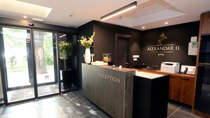 A reception desk with a sign reading "RECEPTION" and "ALEXANDAR II HOTEL". - Hotel Alexandar II (Skopje)