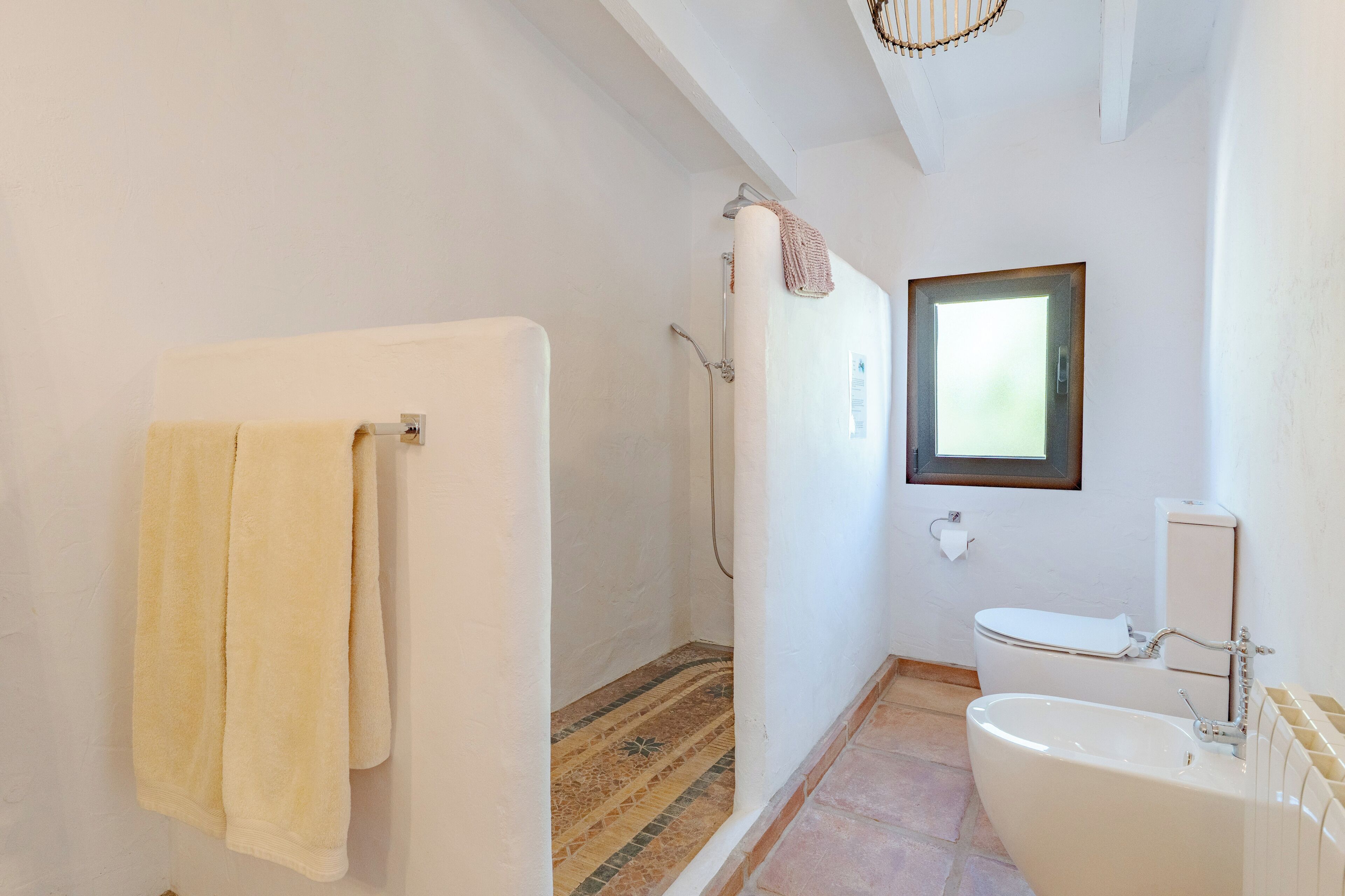 A bathroom with a shower, toilet, and bathtub.