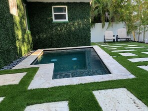 A heated pool, pool loungers