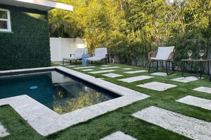 A heated pool, sun loungers - Barefoot Dreams: Dog Friendly, Private Pool,1 Block to Beach by Anna Maria Life Vacation Rentals (Holmes Beach)