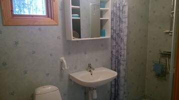 Ein Badezimmer mit Toilette, Waschbecken und Dusche.