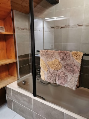 Bathtub, hair dryer, towels, soap