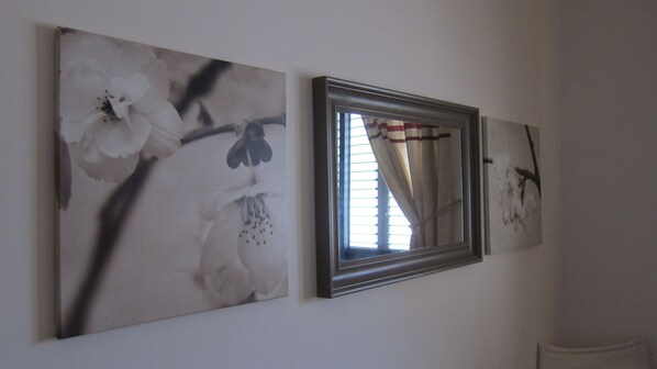 Three framed artworks on a wall, one of which is a mirror reflecting a window with blinds. - STUNNING VILLA with superb views, all-year sun and golf on your doorstep! Heaven (Pissouri)