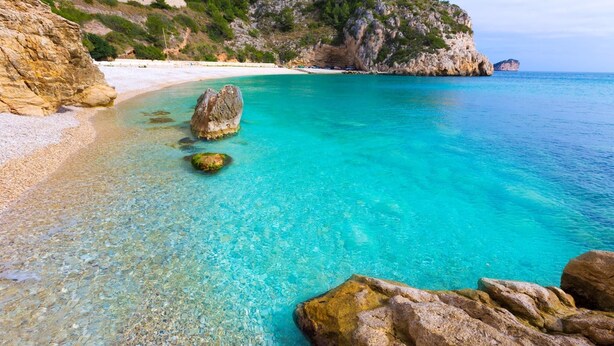 A coastal beach with clear turquoise waters, rocky formations, and a sandy shoreline. - Calas - Javea, Costa Blanca (Javea)