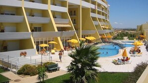A multi-story hotel with a pool area, outdoor seating, and a clear view of the surrounding landscape. - SEA VIEW, SWIMMING POOL, PARKING AND 250 MTRS. THE MARINA AND BEACH (LAGOS)