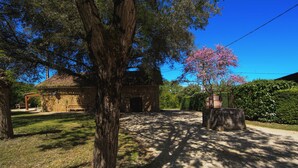 A rustic stone building with a tiled roof, surrounded by a well-maintained lawn and trees. - Beautiful villa for 4 people with private pool   (Urval)