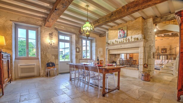 A spacious dining area with a wooden table and chairs, large windows, and a fireplace. - Moulin de Villeverneix and its tower, Neuvic on the banks of the Vern for 6, 8 people (Neuvic)
