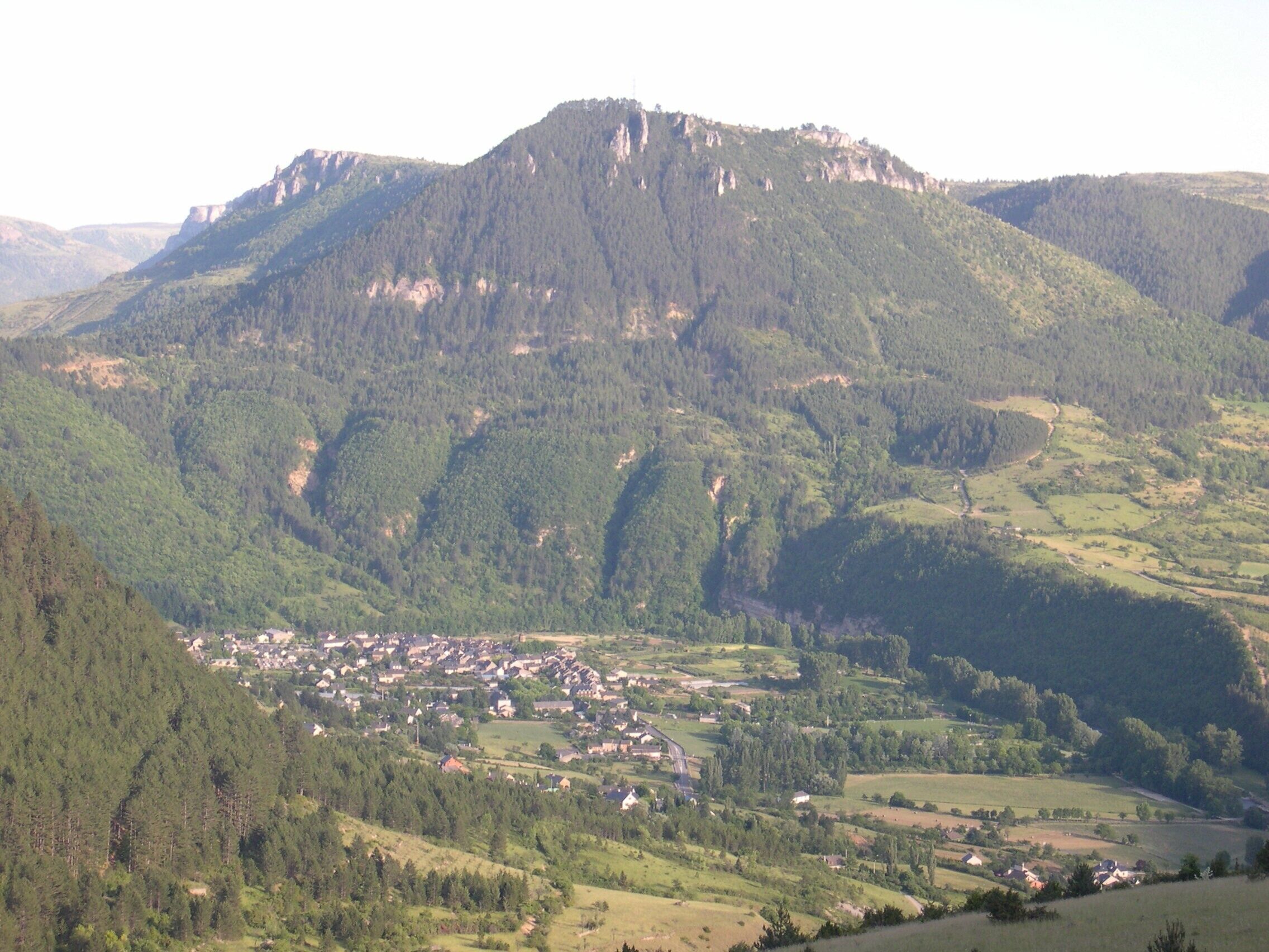 A mountainous landscape with a town nestled in a valley.