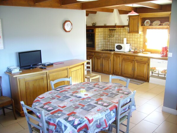 A compact kitchen with wooden cabinets, a microwave, and a coffee maker. - chalet between the mountains and the lakes (montboudif)