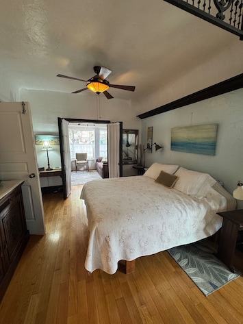 Queen bed is center of this entire space and TV in front of bed.