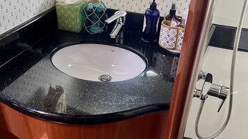 Shower, hair dryer, towels, toilet paper