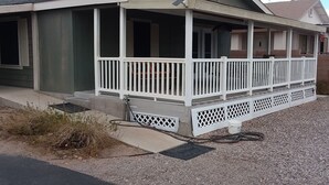 A single-story house with a covered porch and a chimney. - WATERFRONT,PRIVATE BOAT RAMP ,SANDY BEACH GATED COMMUNITY, 3 BEDROOM & 2 BATH (Mohave Valley)