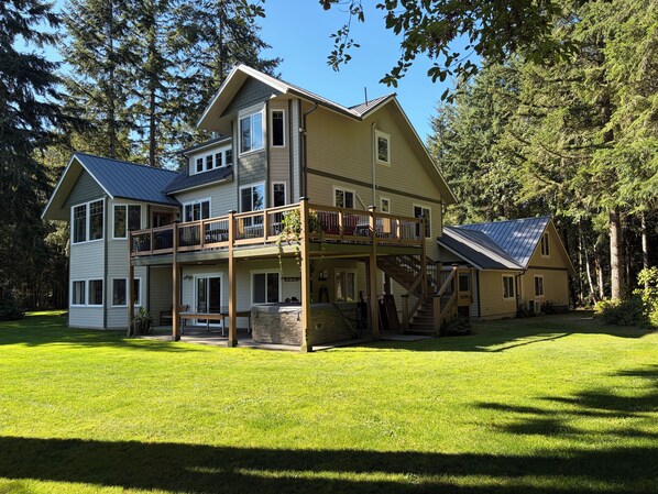 A two-story house with a balcony, a covered porch, and a deck.