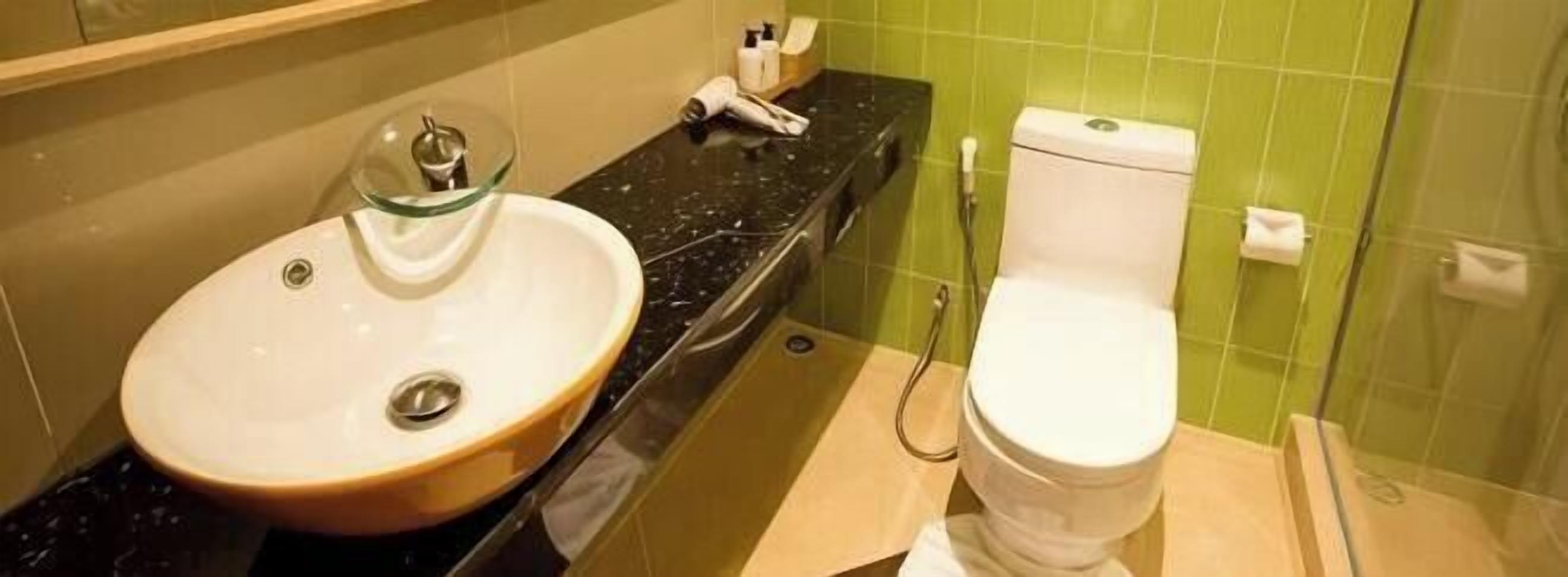 A bathroom with a sink, toilet, and shower.
