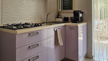 Fridge, stovetop, coffee/tea maker, cookware/dishes/utensils
