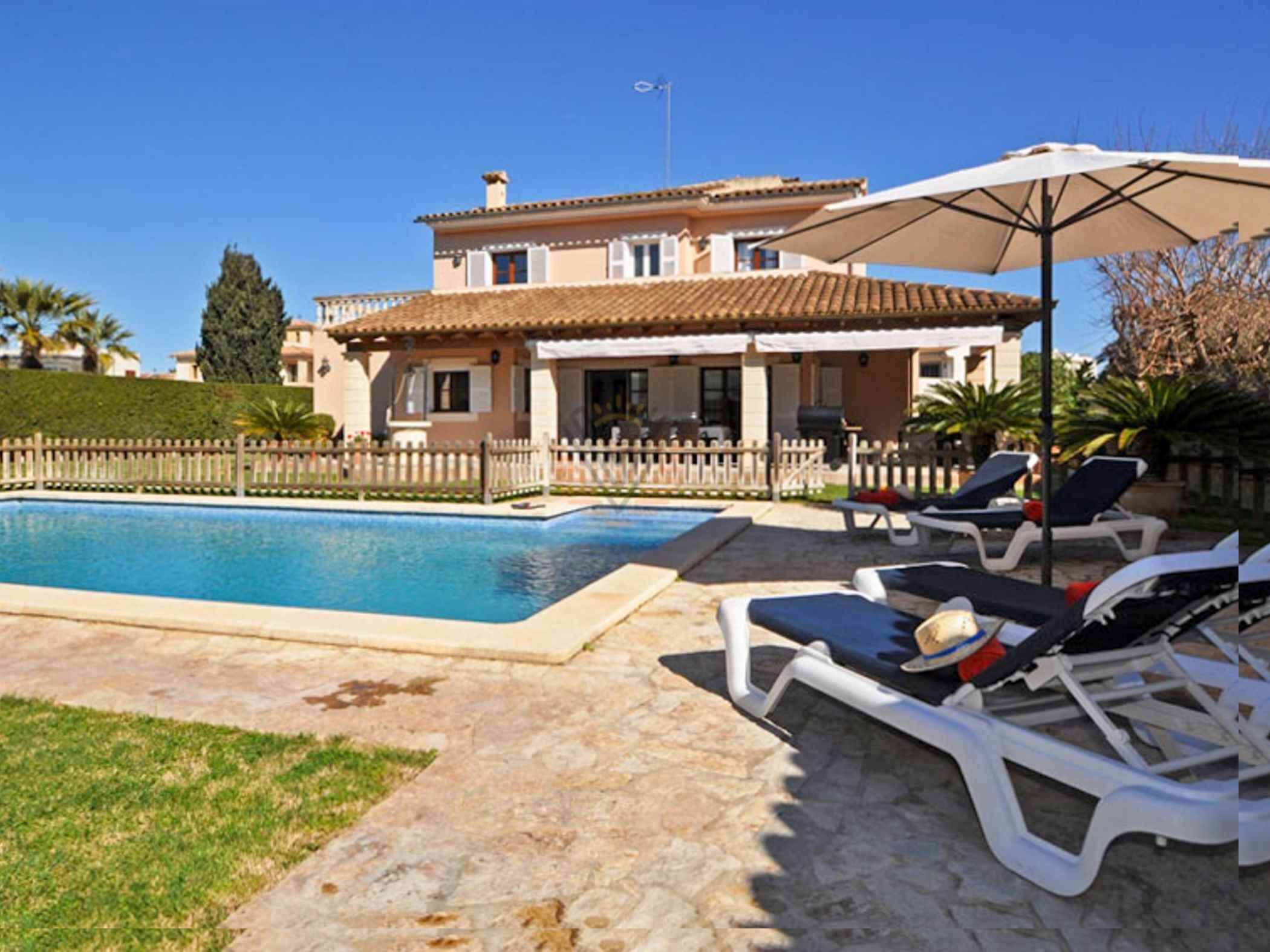 Une villa avec piscine, espace extérieur aménagé et jardin clos.