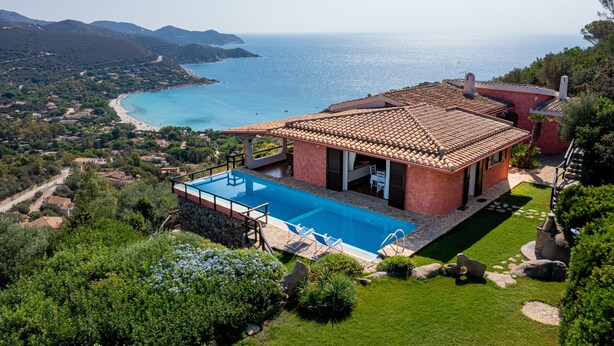 A Mediterranean-style villa with a private pool, terracotta roof, and scenic ocean views.