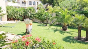 A Mediterranean-style villa with a tower, surrounded by lush greenery and palm trees. - Calypso - Javea, Costa Blanca (Javea)