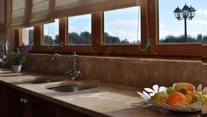 A kitchen with a marble countertop, two sinks, a potted plant, and a fruit basket. - Son Horlandis, Country house in Petra, Mallorca (Petra)
