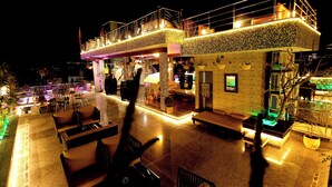 A two-story building with outdoor seating and a balcony. - Aman Homestay a Boutique Hotel (Agra)