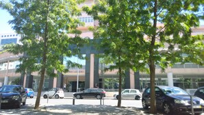 A parking lot with several cars, trees, and a building with a sign reading "JARDIM AMERICA". - QUAD 2 with Balcony, Garage, A.C. (Cold or heat), 24/7 security  (Lisboa)