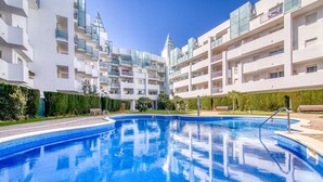 A modern hotel with a swimming pool, multiple balconies, and a well-maintained garden. - ROYAL MARINE 2 240 Roses (Rosas / Roses)
