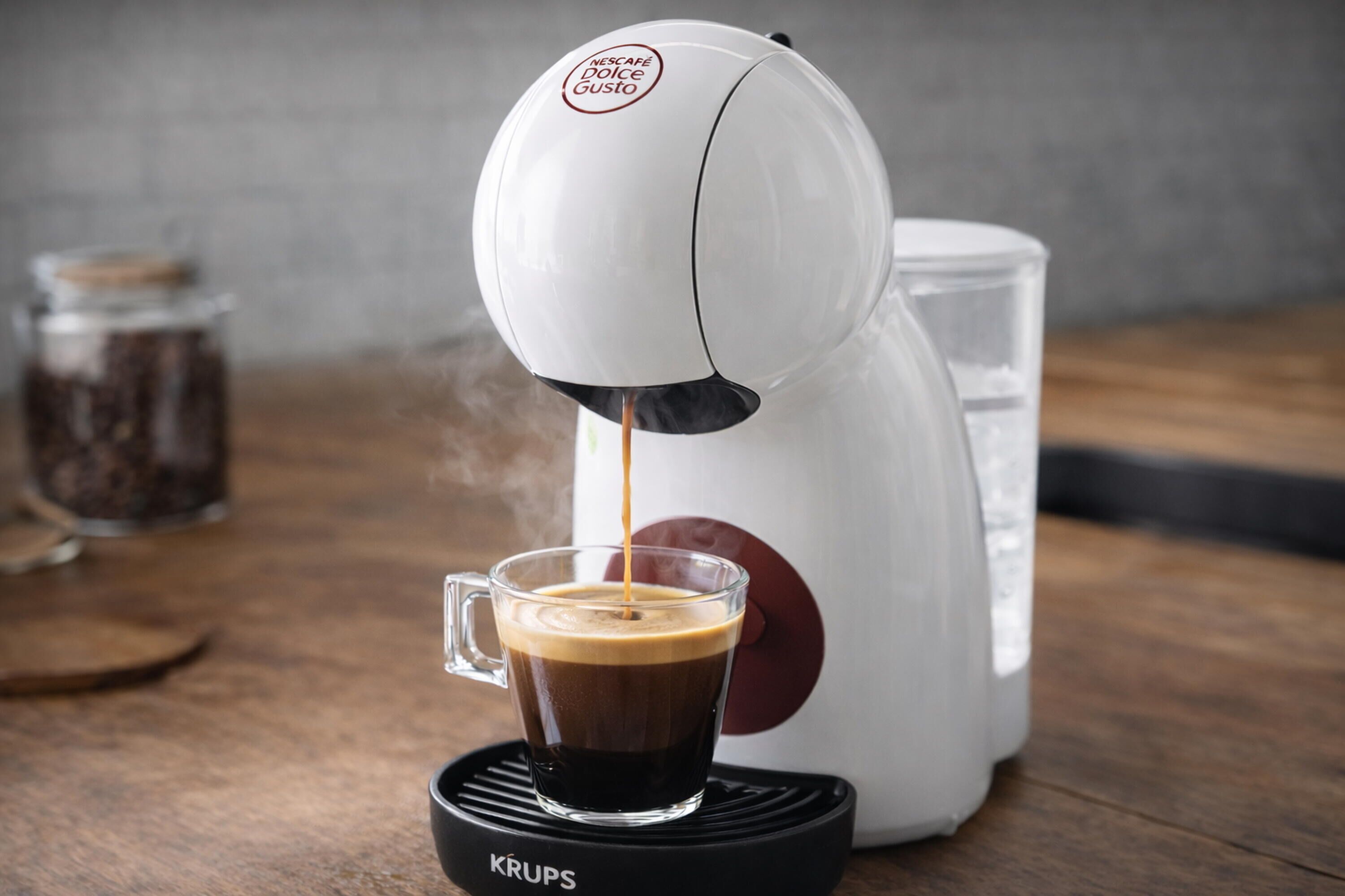 A coffee machine dispensing coffee into a cup.