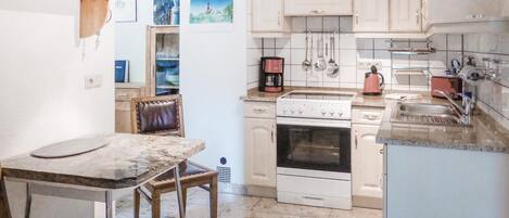 Fridge, stovetop, dishwasher, coffee/tea maker