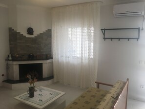 Comfort Apartment, Multiple Beds | Living room | 48-inch flat-screen TV with digital channels, Smart TV, fireplace - Calista Luxury Appt (Kassandra)