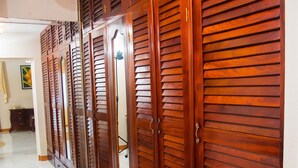 A hallway with a wooden wardrobe with multiple doors and drawers. - Beautiful Gated Community Vacation Home, Close to all Tourist Attractions (St. Anne's Bay)