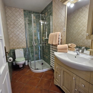 Shower, hair dryer, slippers, towels