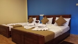 A hotel room with two beds, each with a wooden headboard, white linens, and brown pillows. - Hotel Araliya (Kekirawa)