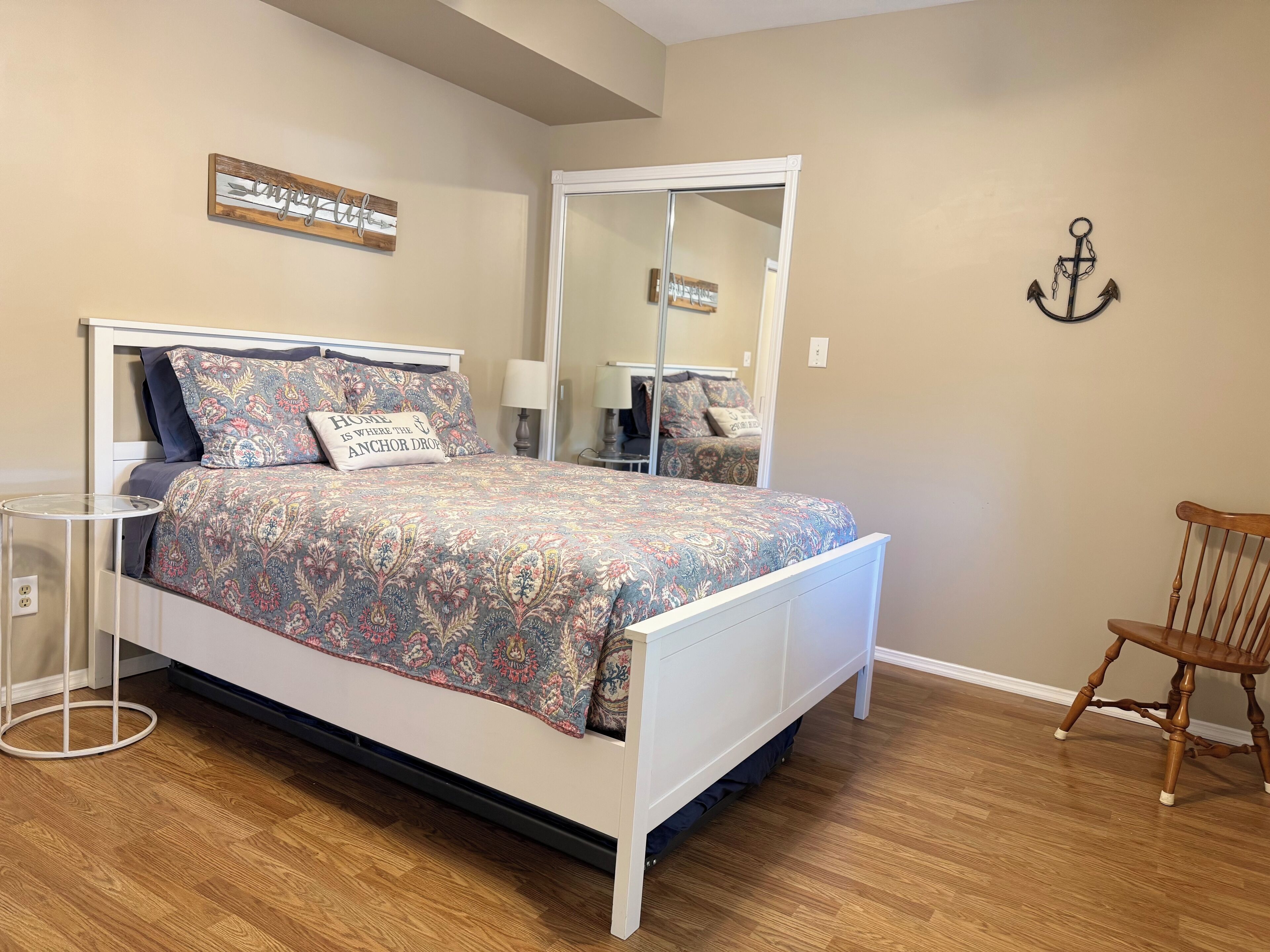 Primary Bedroom: Queen bed, twin trundle, door to sunroom, en suite bathroom