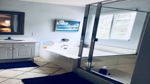 Bathtub, hair dryer, towels, shampoo