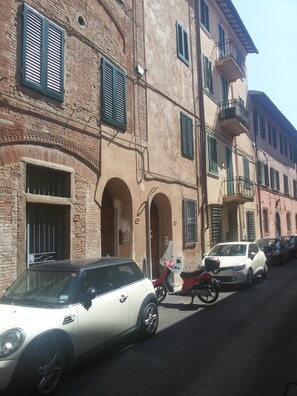 Stroll through historic streets lined with traditional buildings featuring arched doorways and shutters.