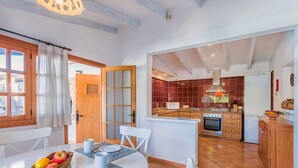 A modern kitchen with a central island, wooden cabinets, and a built-in oven.