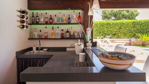Une cuisine équipée d’un bar, d’un évier et d’un plan de travail avec un saladier.