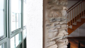 A stone wall with a window and a staircase.