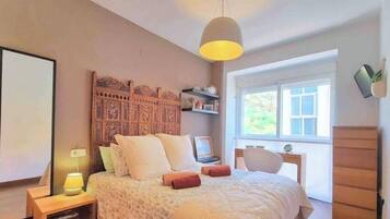 2 habitaciones, escritorio y tabla de planchar con plancha