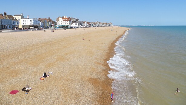A wide sandy beach with buildings along the shore. - Very popular modern 2 bedroom apartment sleeps 4  located opposite Deal Pier.   (Deal)