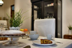 A table with a cake, a cup, and a bowl. - Real Umberto I - Kalsa (Palermo)